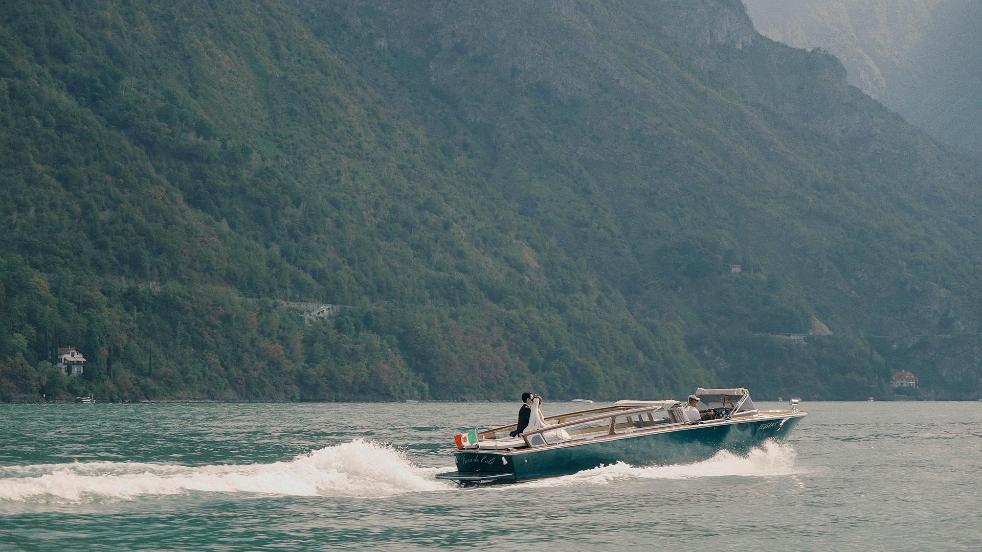 A couple on a boat in Lake Como, Italy about to get married.